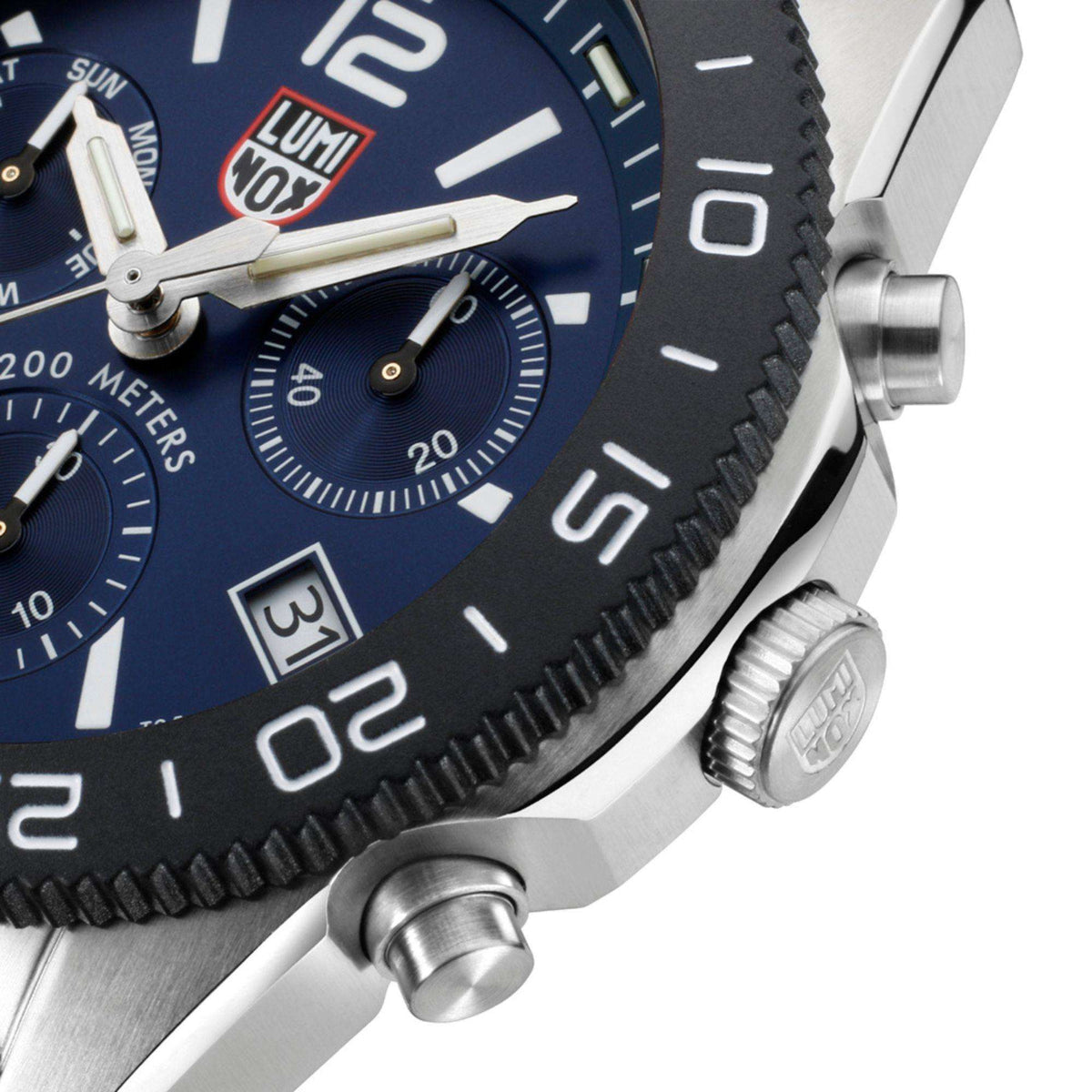 Blue dial diver watch close-up with knurled bezel and side crown