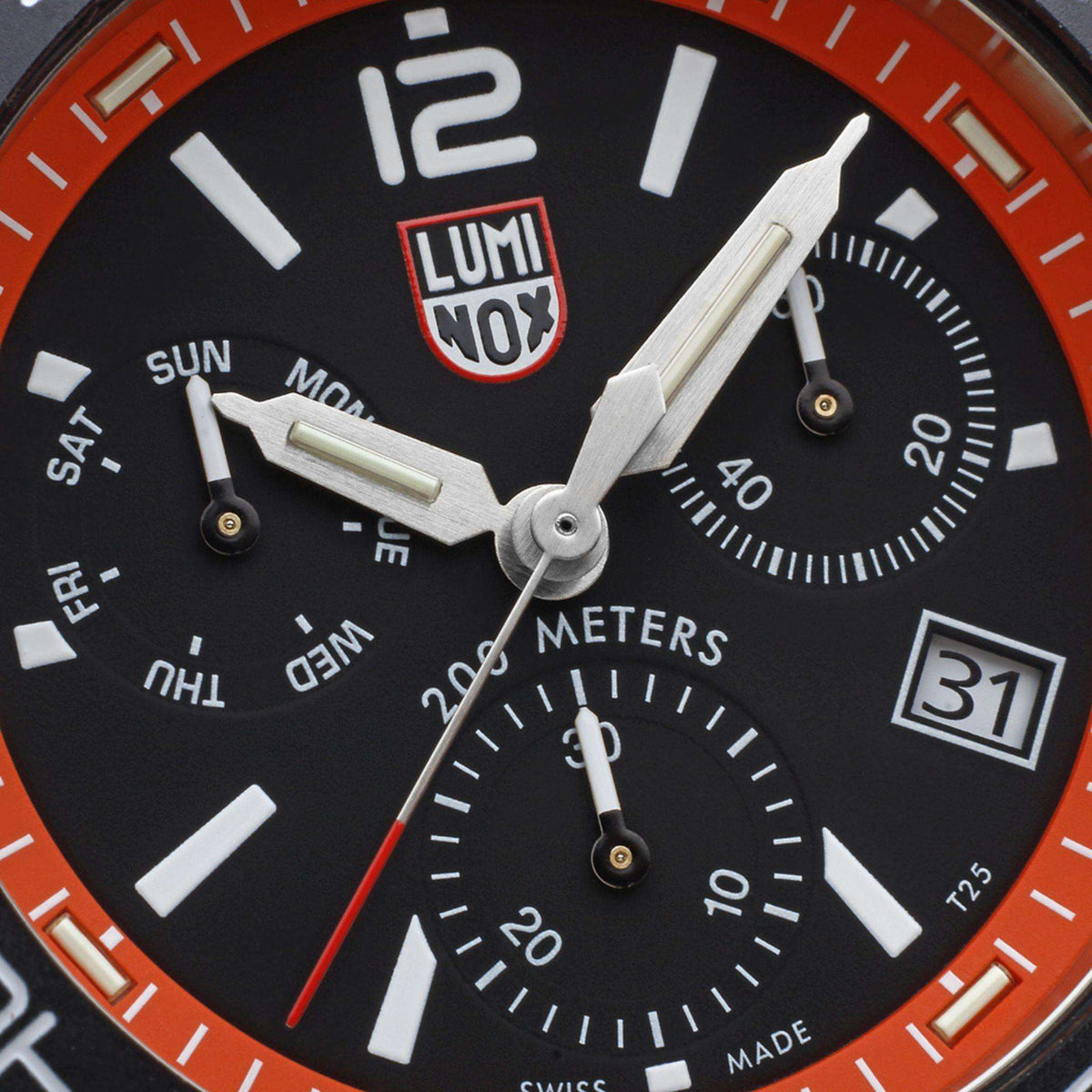 Luminox diver chronograph dial with black face, orange bezel, and subdials