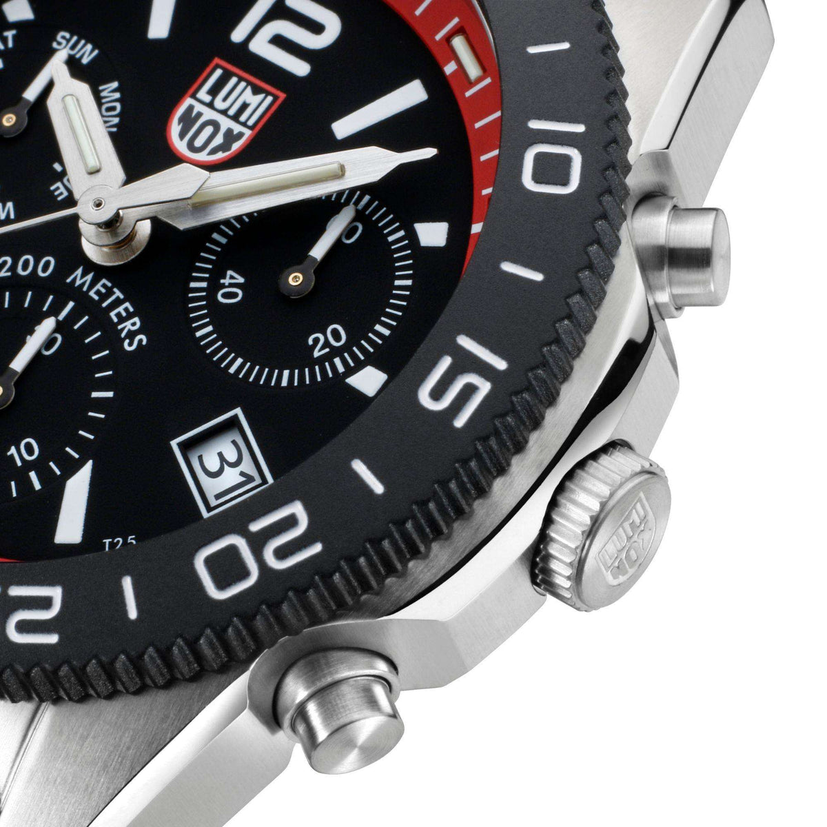 Diver chronograph watch close-up of metal case edge and crown detail beside black dial.