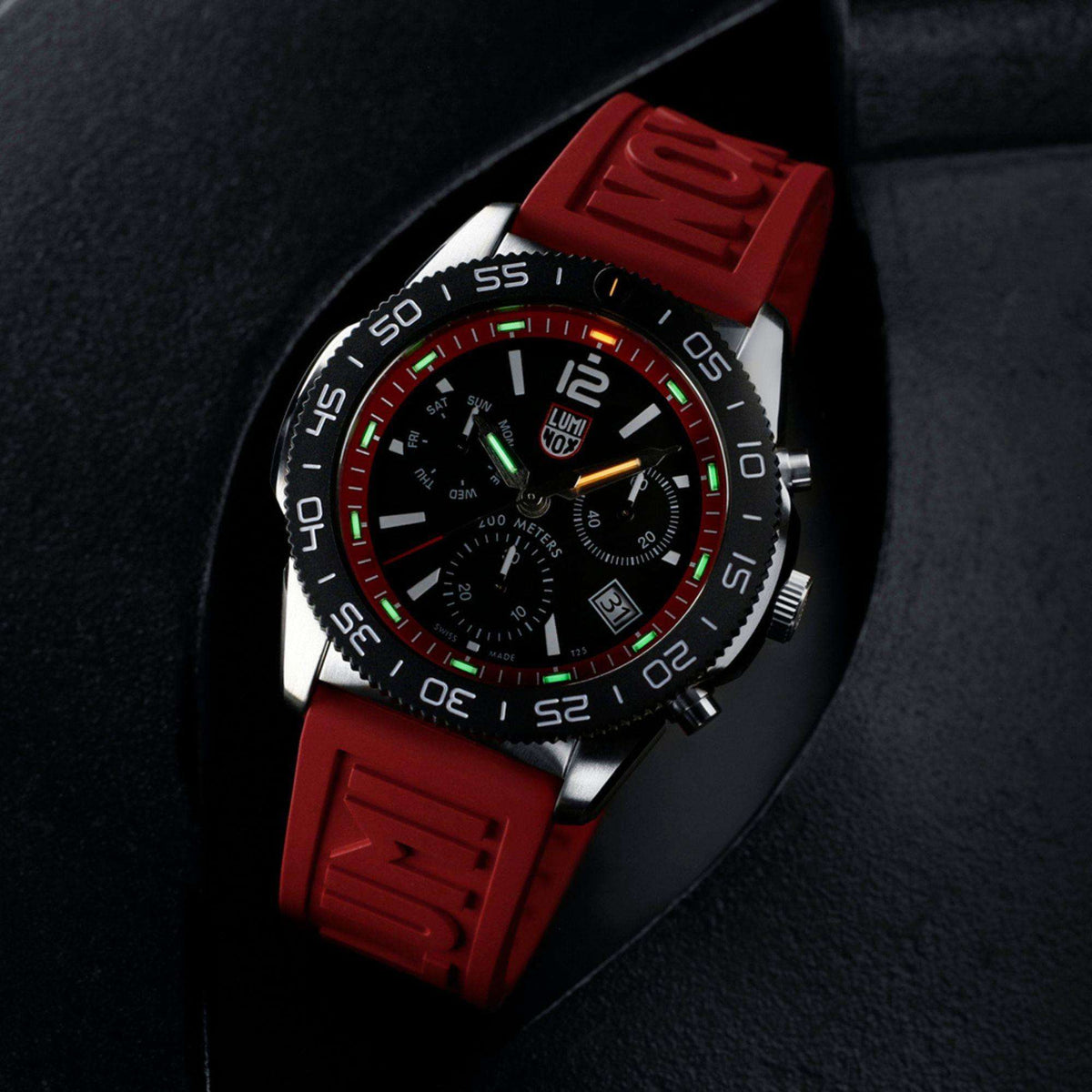 Men's diver chronograph watch with black dial, red rubber strap, colorful luminous markers