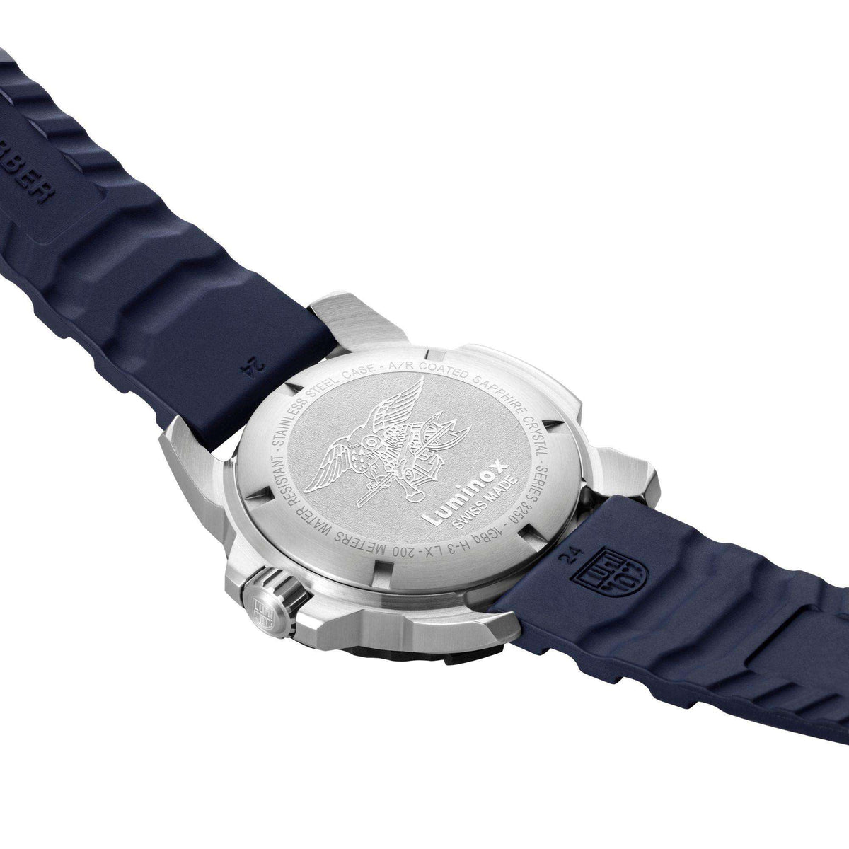 Stainless steel case back with engraved sea emblem on navy rubber strap