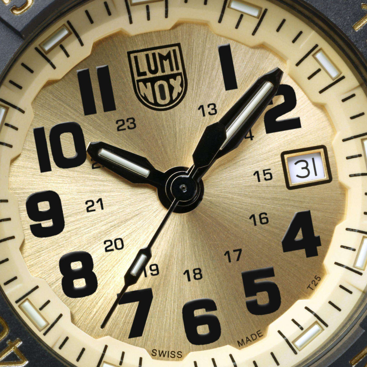 Watch dial closeup with LUMINOX logo, gold ring, black hands, date marker
