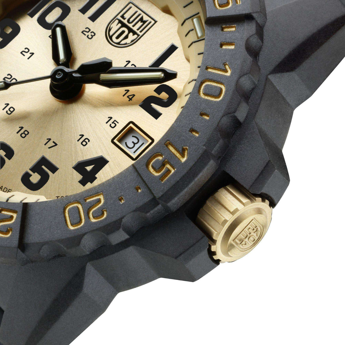 Watch side closeup with gold crown, engraved bezel numbers, and black case