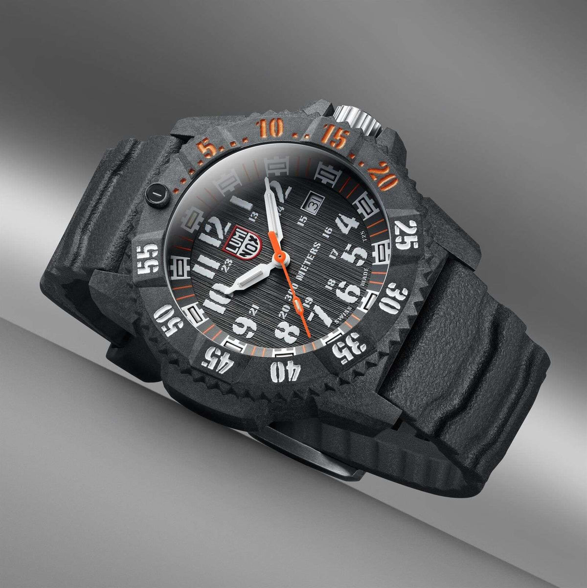 Side angle carbon watch with black dial, orange minute track, luminous markers and knurled bezel.