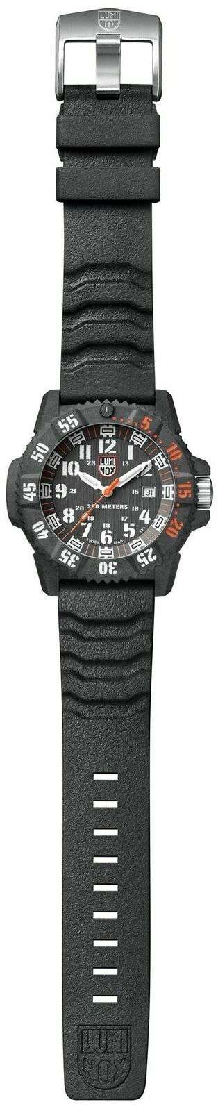 Straight-on view of black silicone strap carbon watch with black dial, orange accents, and date window.