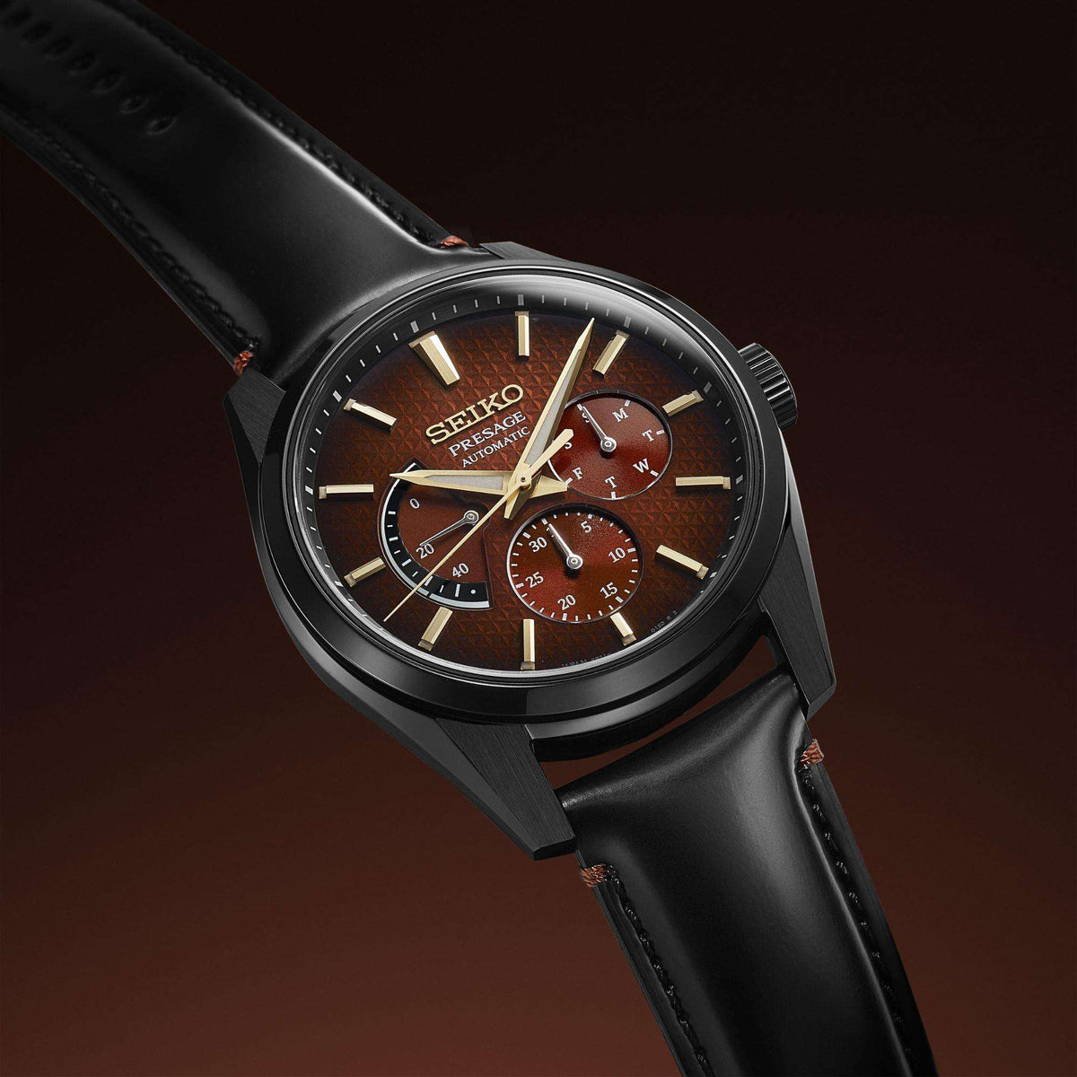 Men's black case watch with red-brown dial and three subdials, gold baton markers