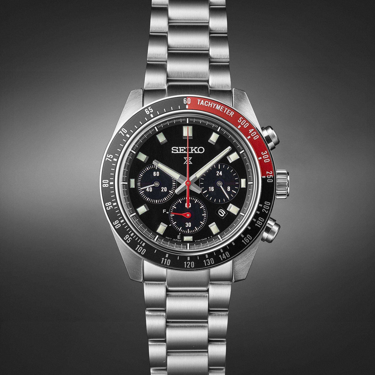 Men's stainless steel chronograph watch with black dial, red seconds hand, metal bracelet.