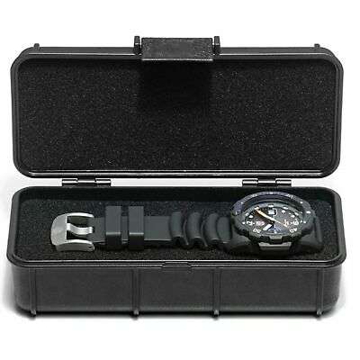 Black rubber diver watch laid in open black carrying case with orange crown detail