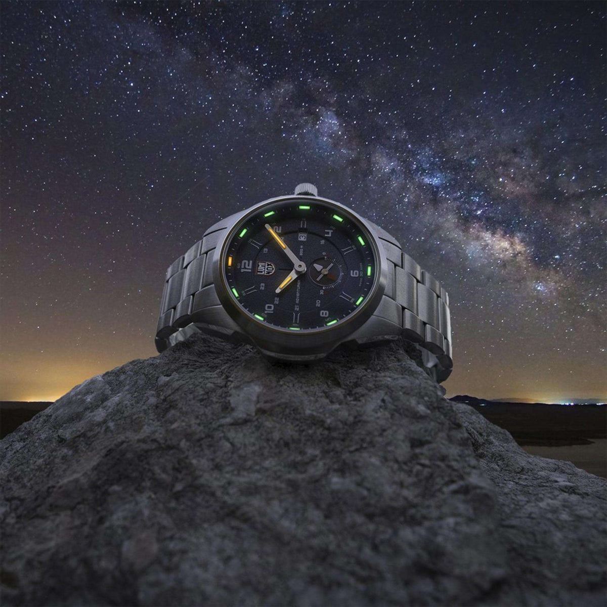 Men's black automatic field watch with green glowing markers on dark dial