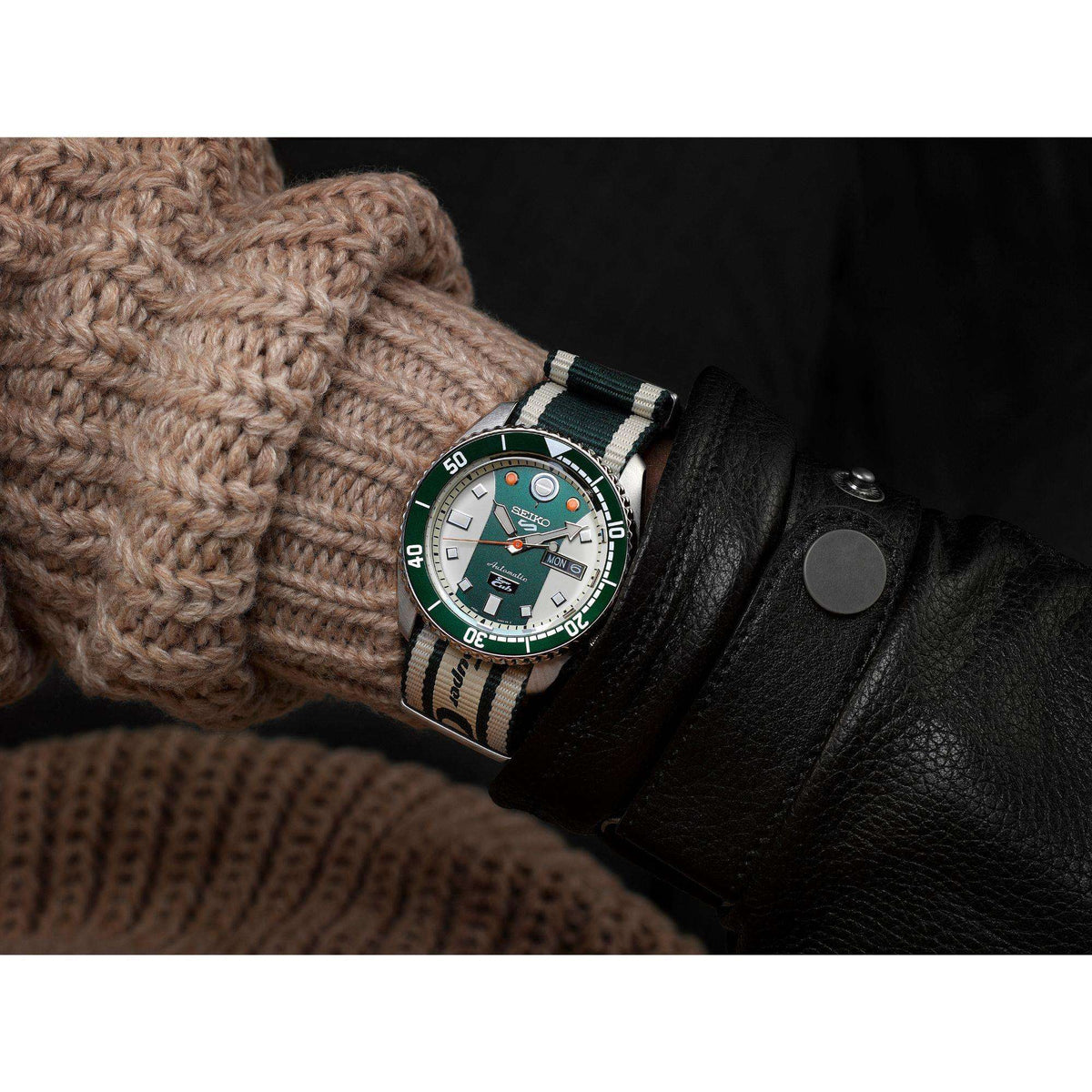 Automatic watch on striped fabric NATO strap, green dial with "MON" date