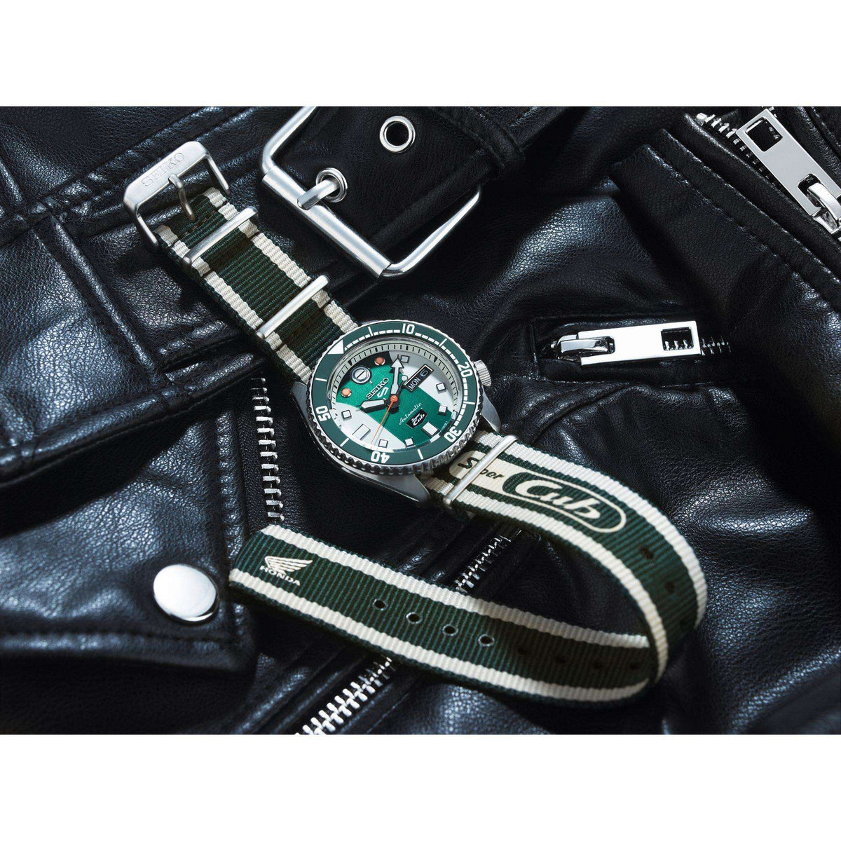 Men's watch on black leather jacket with striped fabric NATO strap and green dial