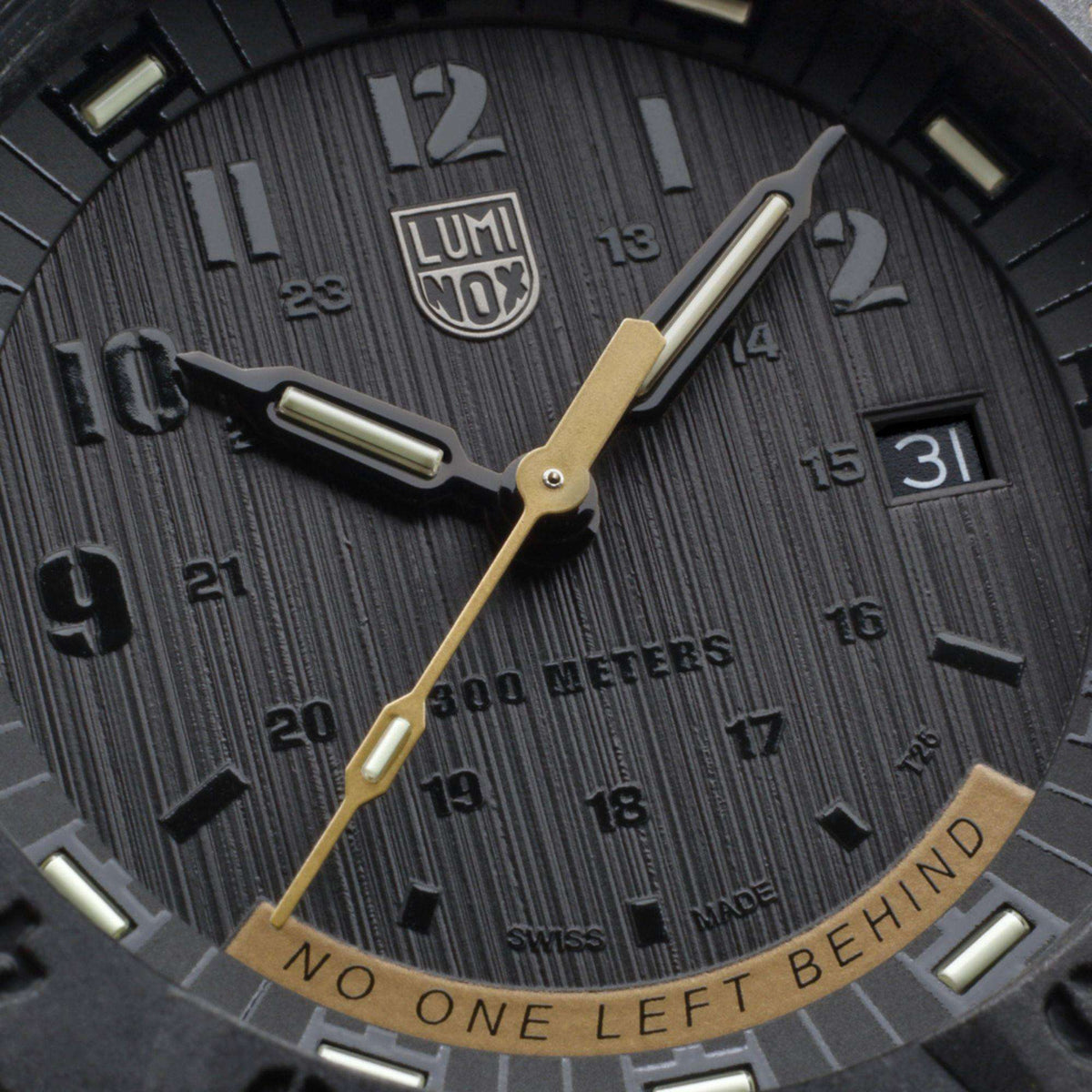 Luminox watch dial close-up with gold hands, dark markers, and date window at 3 o'clock