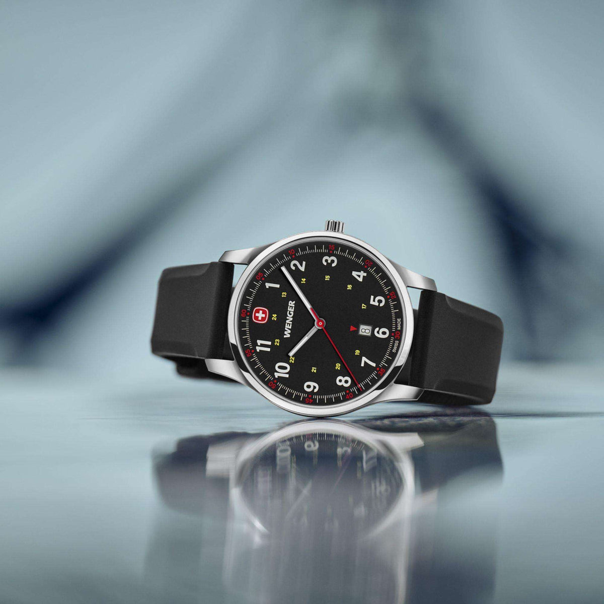 Men's analog wristwatch close-up, black dial with red seconds hand and accents