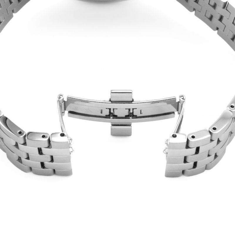 Silver stainless bracelet links and clasp, blue dial partly visible