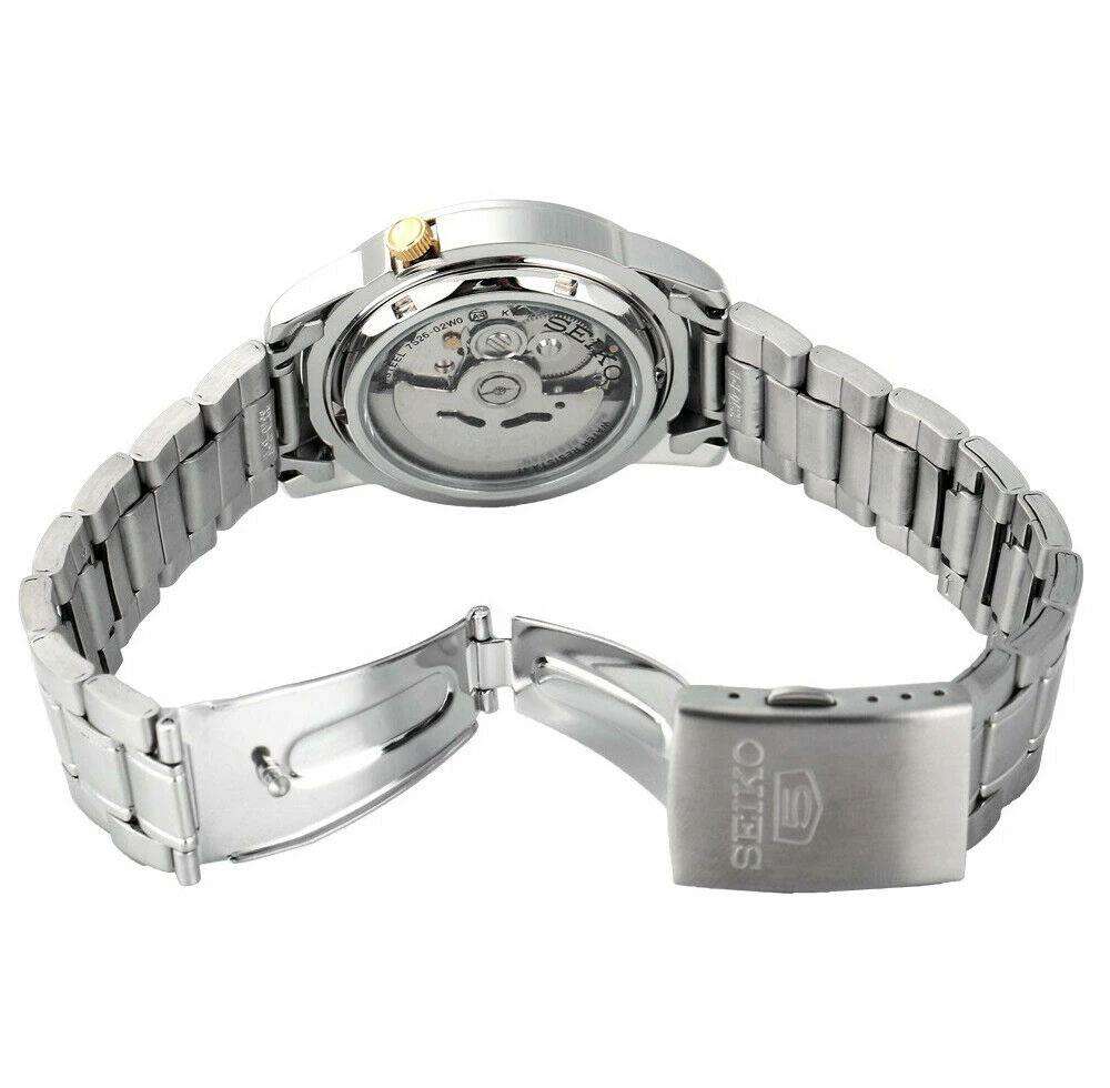 Stainless steel wristwatch caseback with bracelet links, visible inner mechanism window