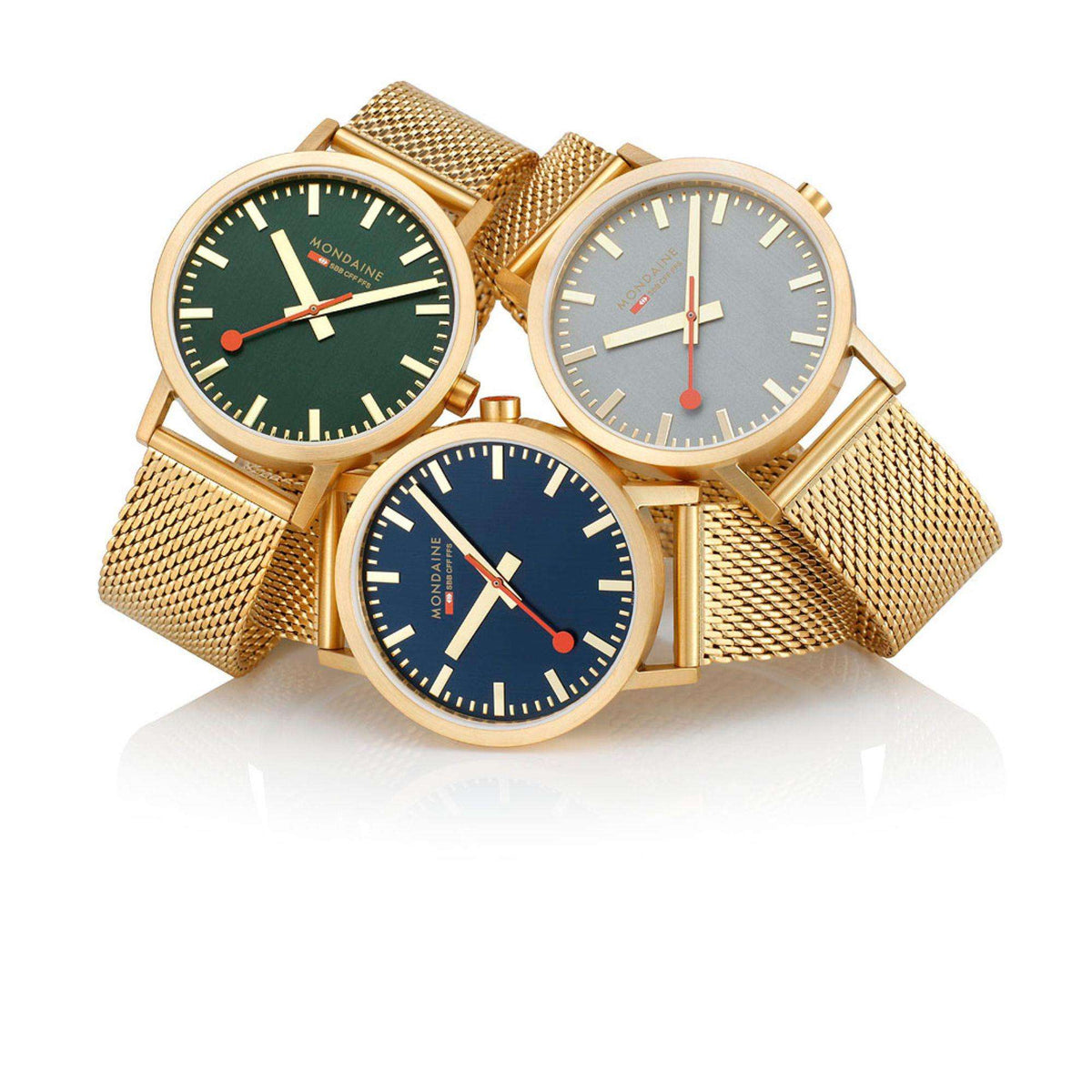 Three Mondaine Classic gold-tone mesh bracelet watches with blue and green dials
