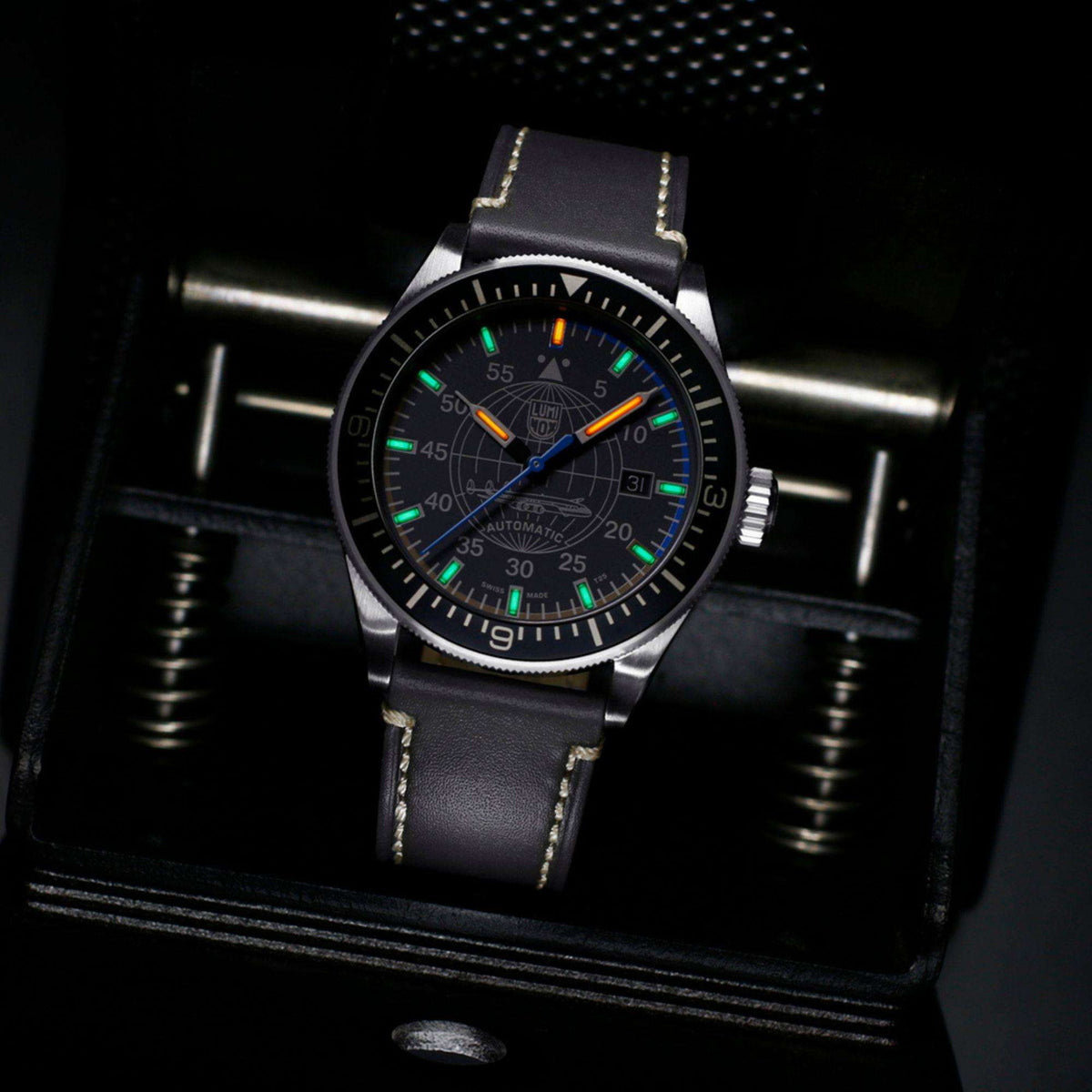 Luminox Constellation XA.9602 low light view showing illuminated hands and hour markers on grey dial with leather strap