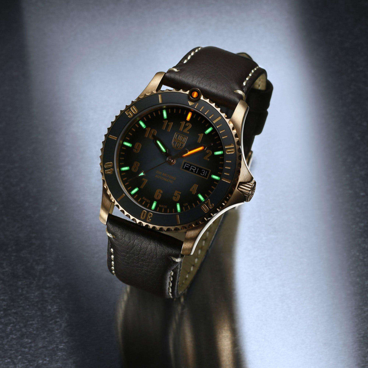 Men's automatic watch angled view with green luminous dial, black leather strap, rose-gold case