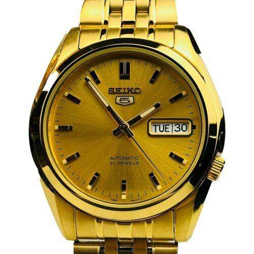 Close-up of Seiko 5 SNK366K1 automatic watch with a gold dial, gold PVD stainless steel, and a day-date window
