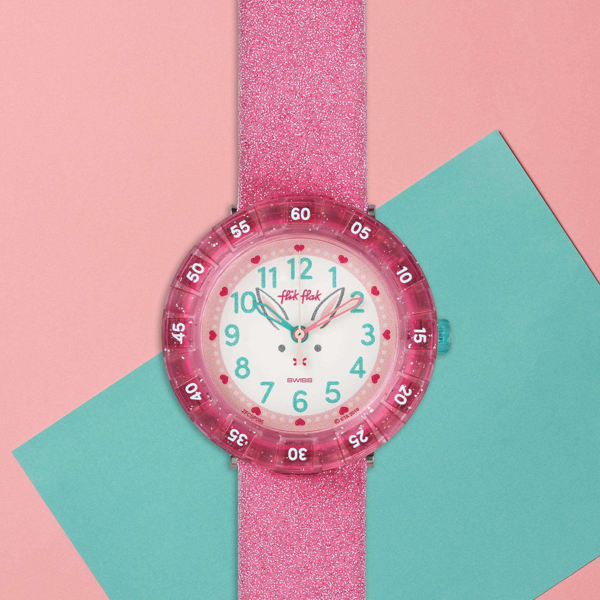 Girls pink glitter silicone watch, white face with colorful numbers and turquoise hands