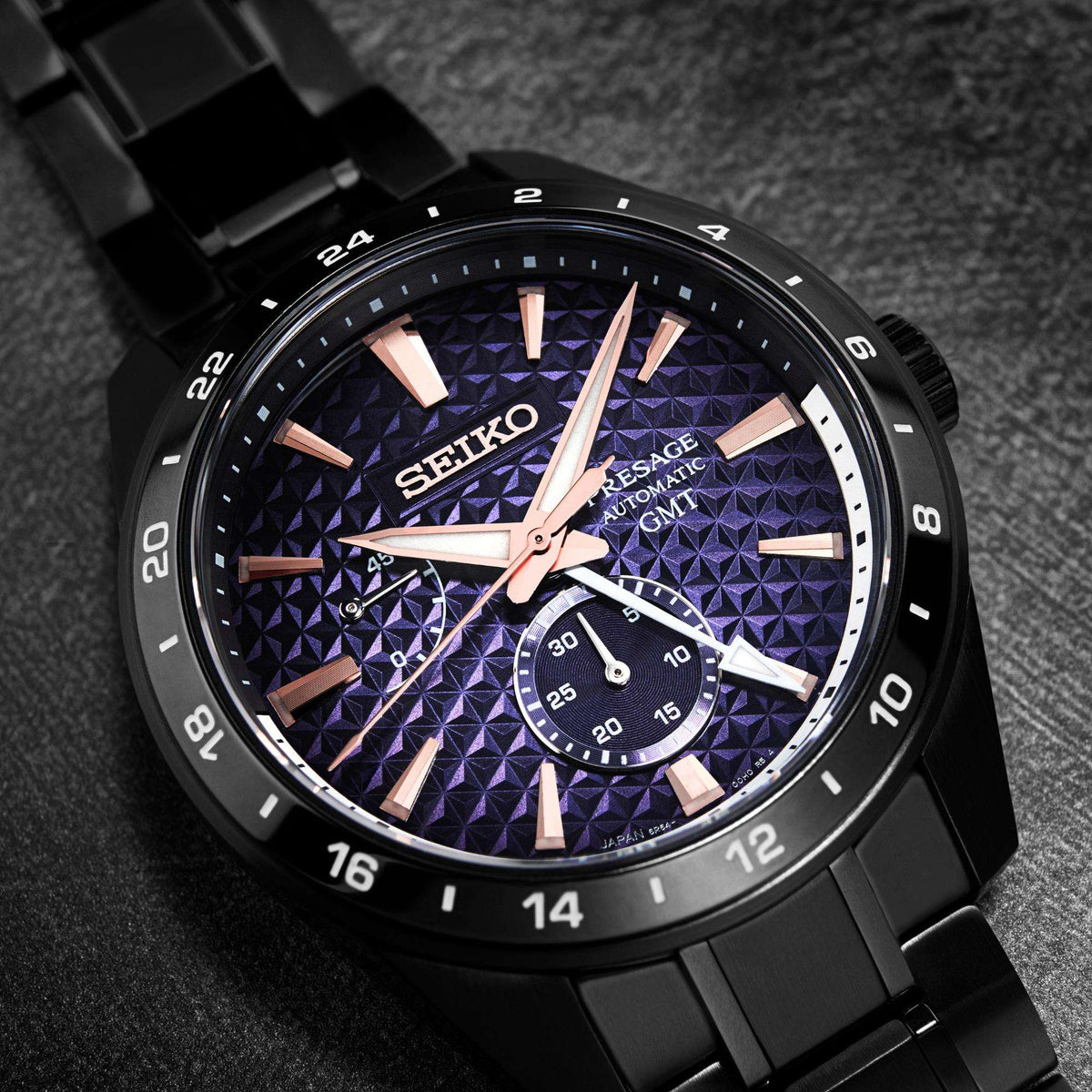 Close-up angled studio shot emphasizing the rose gold hands, indices, and the intricate texture of the blue gradient dial.