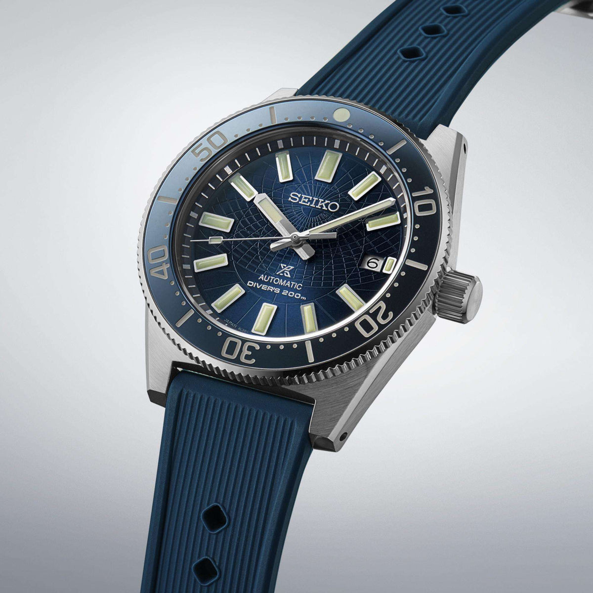 Angled view highlighting the steel case, crown, and the complex pattern on the blue dial.