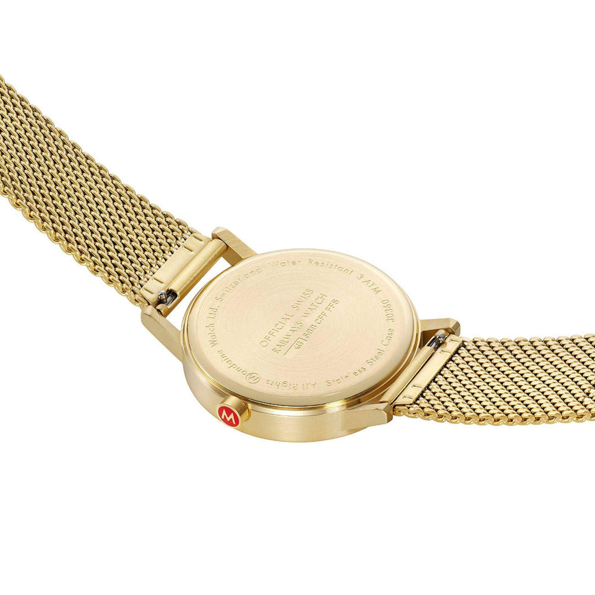 Gold-tone watch caseback close-up with engraved markings and mesh bracelet links