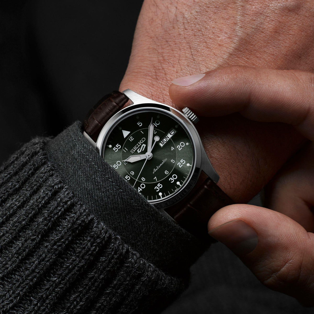 Seiko 5 Sports SRPJ89K1 green dial on wrist view