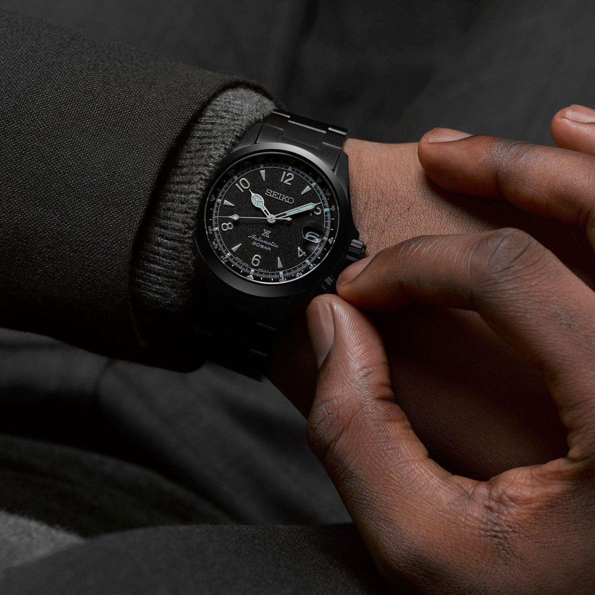 Person adjusting Seiko Prospex Black Series Night Alpinist watch SPB337J1 on their wrist