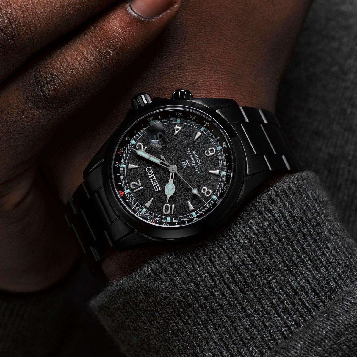 Seiko Prospex Black Series Night Alpinist wristwatch on a persons wrist with a dark background
