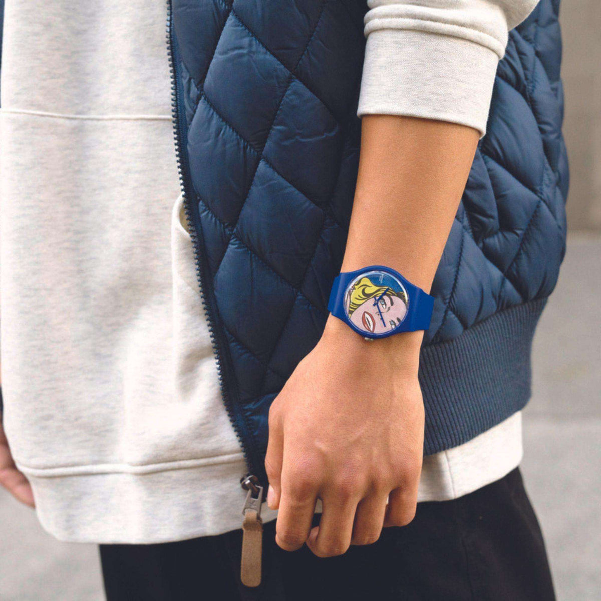 Blue silicone wristwatch on wrist with round comic portrait face