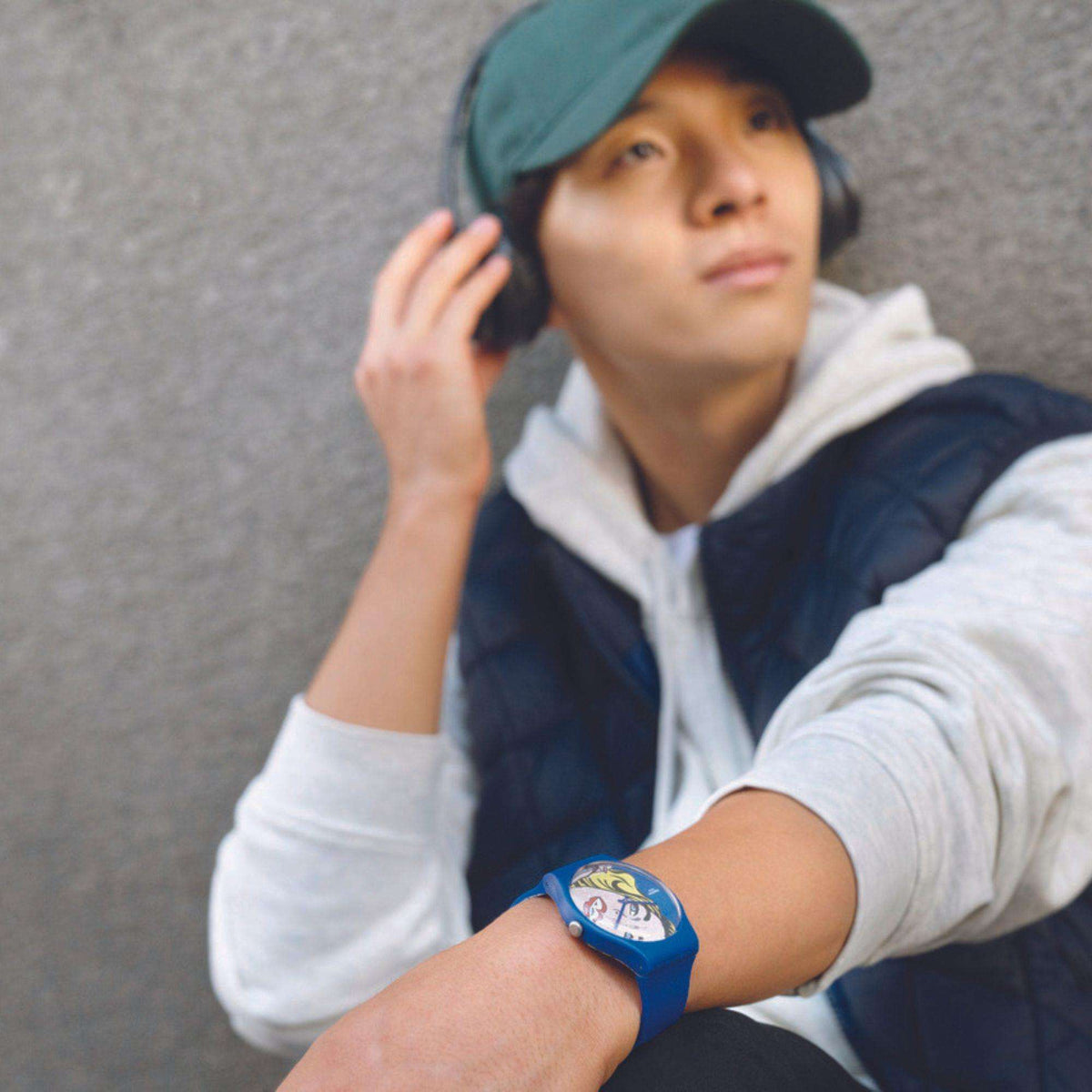 Blue silicone watch on wrist with comic-style portrait dial
