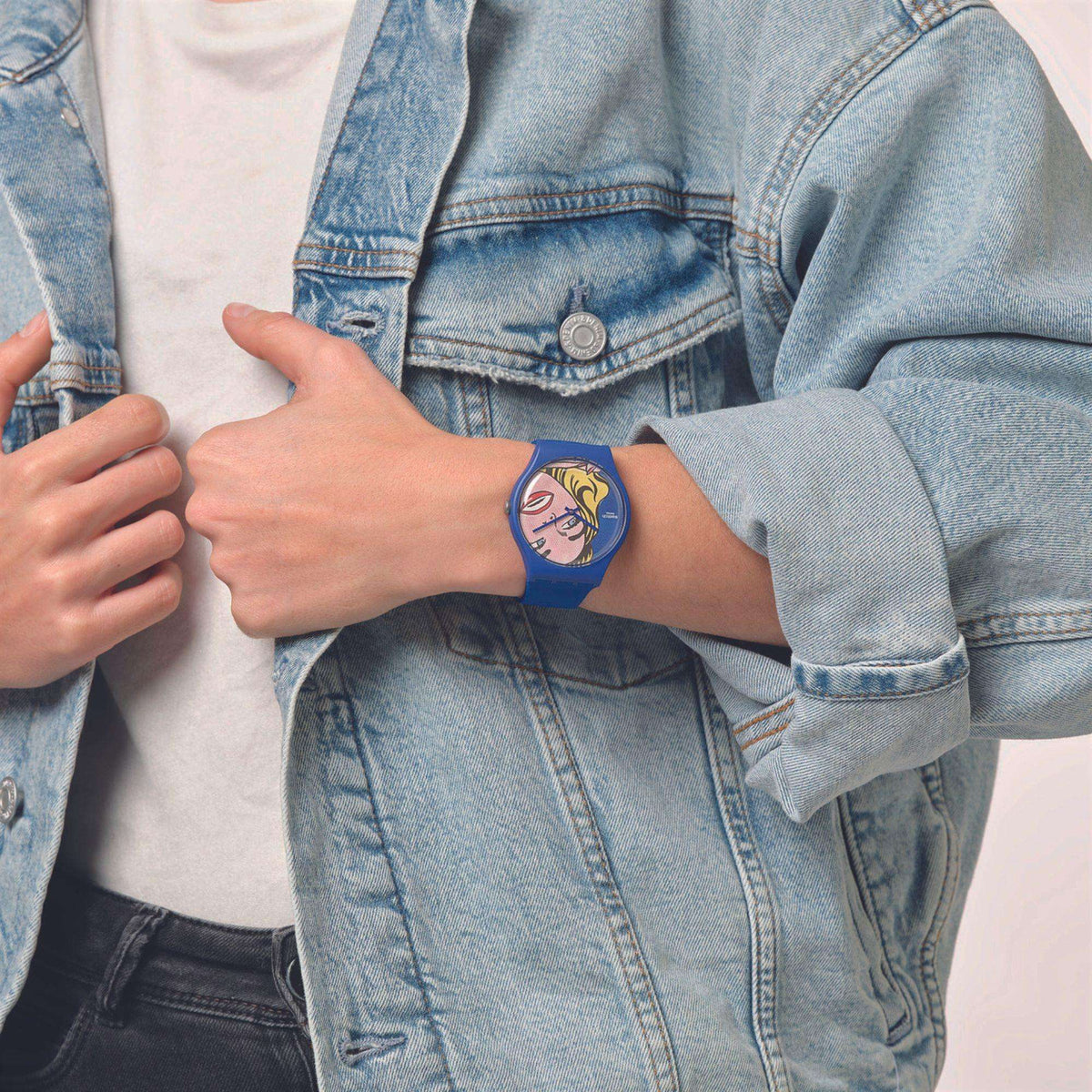 Blue silicone strap Swatch wristwatch with pop-art girl face dial
