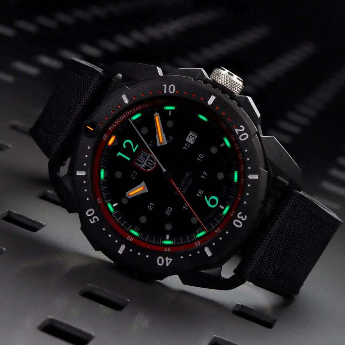 Luminox ICE SAR Arctic XL.1051 watch with black/red dial glowing green in dark setting