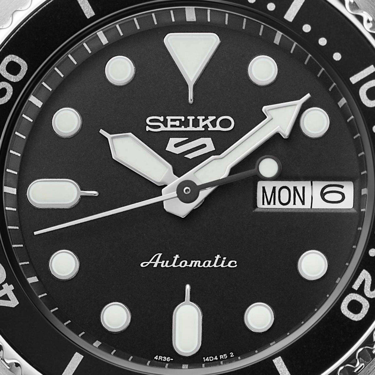Seiko watch face with black dial and white markings