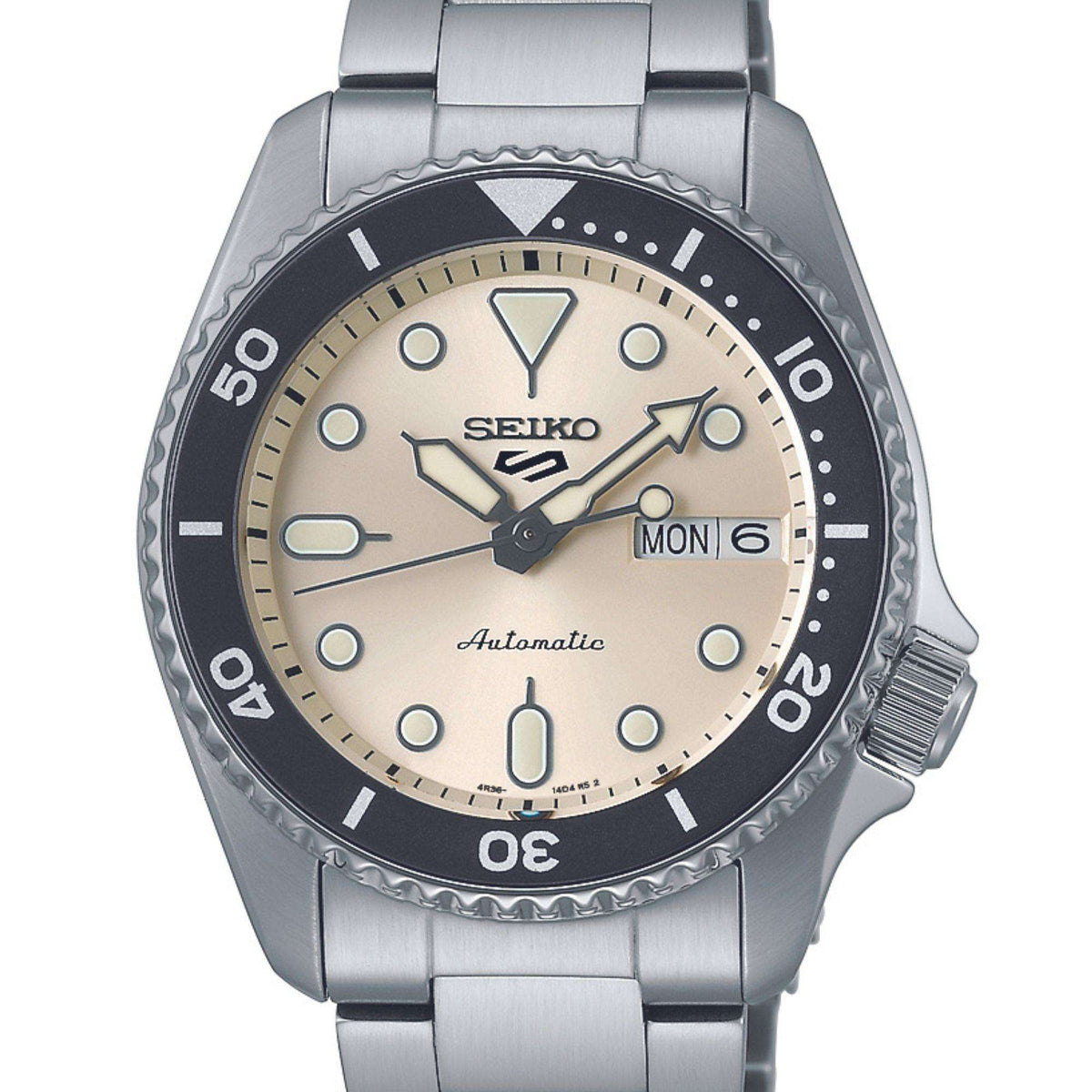 Steel bracelet watch with cream dial, black bezel, crown at 3 o’clock, MON 6