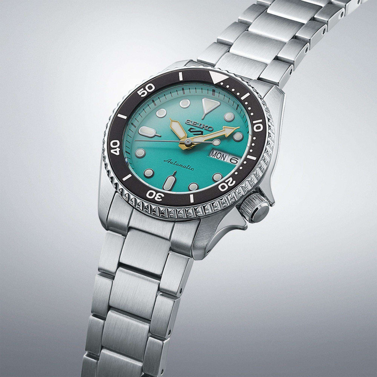 Seiko SRPK33K1 'Midi' Reissue watch floating against a gradient background, showing the full multi-link bracelet.