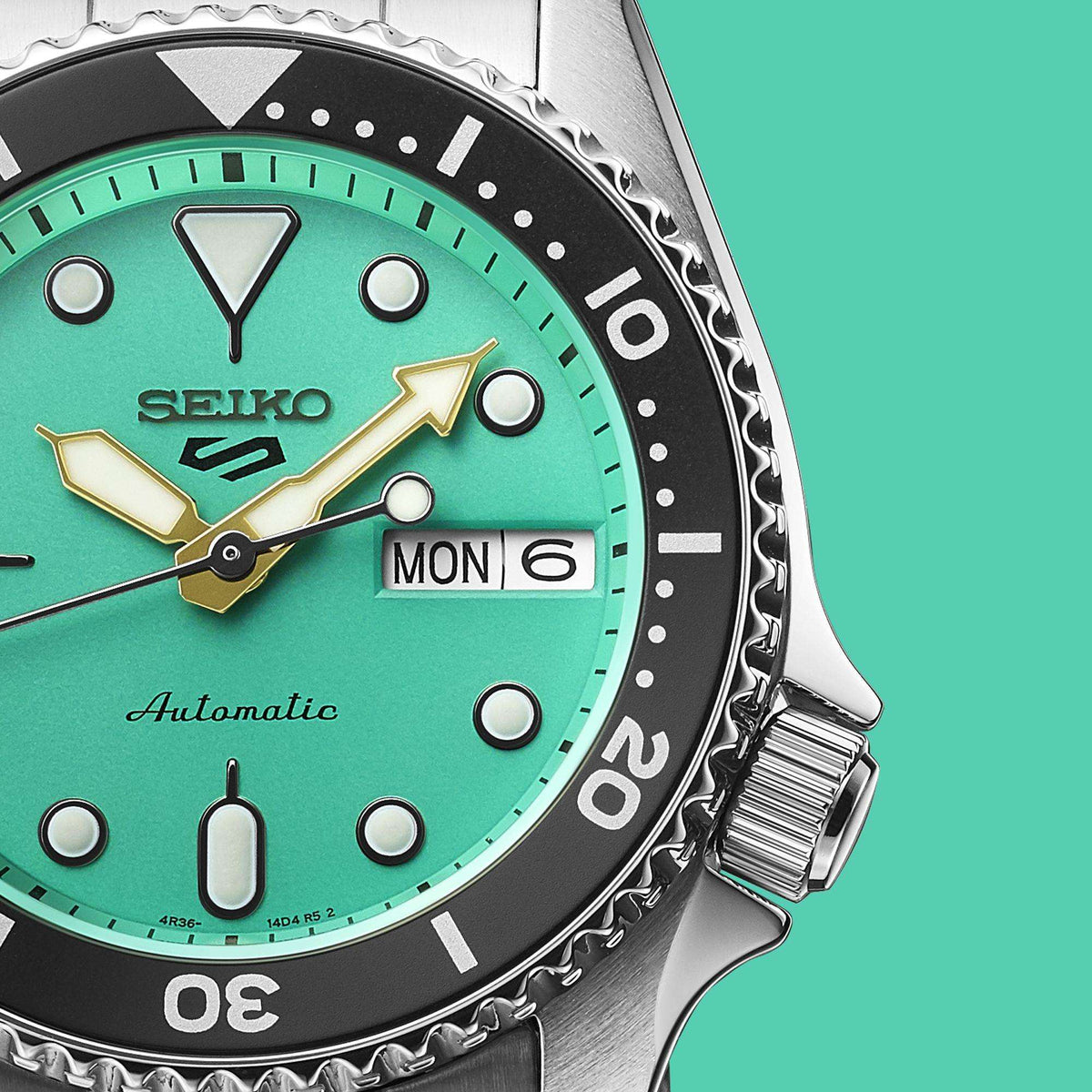 Close-up of Seiko 5 Sports Midi Reissue SRPK33K1 dial, highlighting the day-date window and the black bezel.