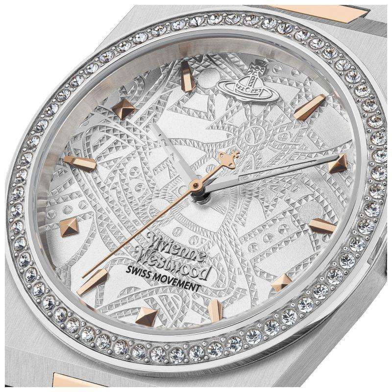 Silver watch dial close-up with patterned engraving, crystal bezel, rose-gold hands