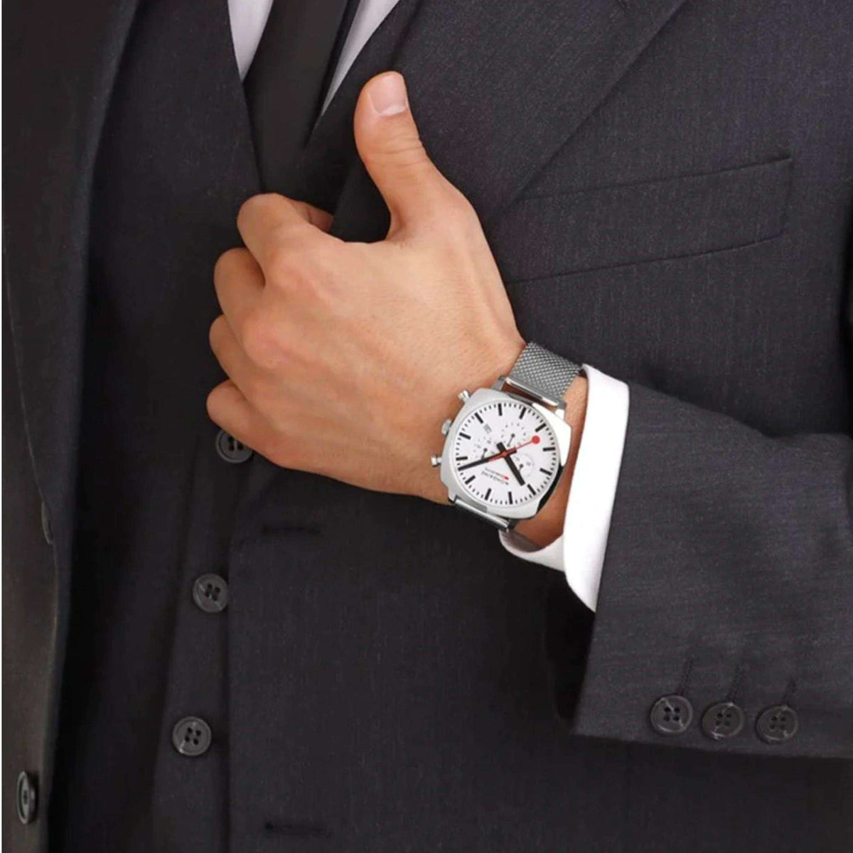 Mondaine Grand MSL.41410.LBV.SET chronograph watch styled on wrist with mesh bracelet and dark suit