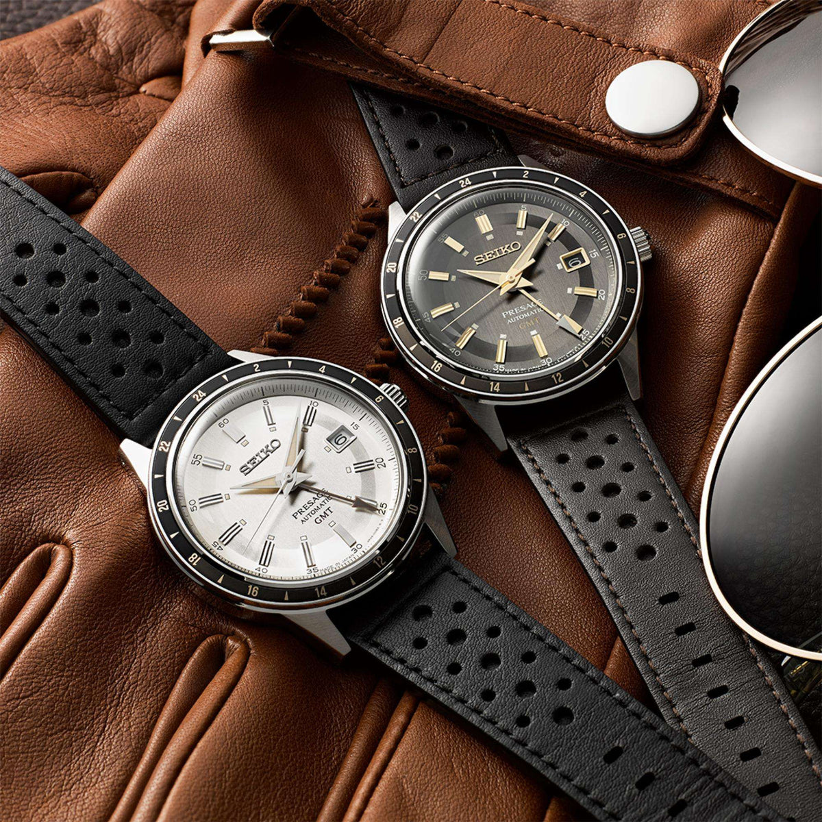 Seiko Presage Stone Style 60s Road Trip GMT SSK011J1 silver dial next to grey dial variant on brown leather gloves
