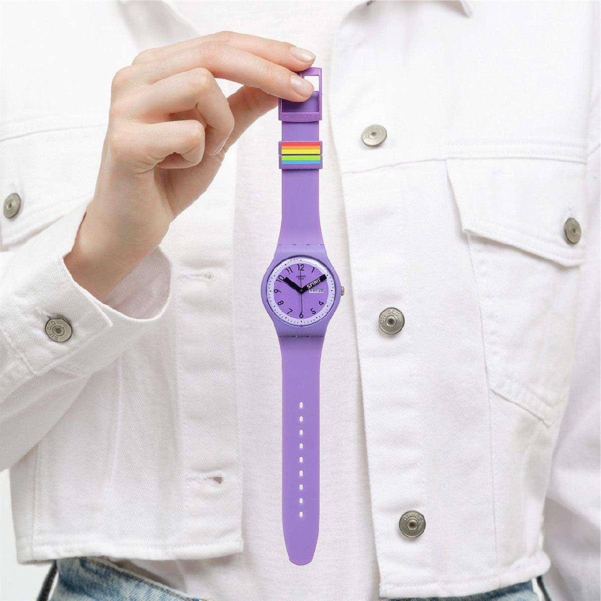 Purple quartz wristwatch worn on wrist with rainbow-striped clasp