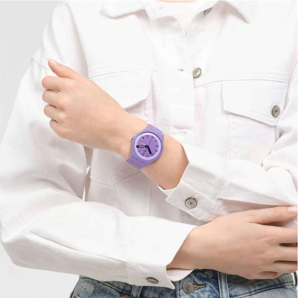 Purple quartz wristwatch on wrist, purple dial with rainbow-striped accents