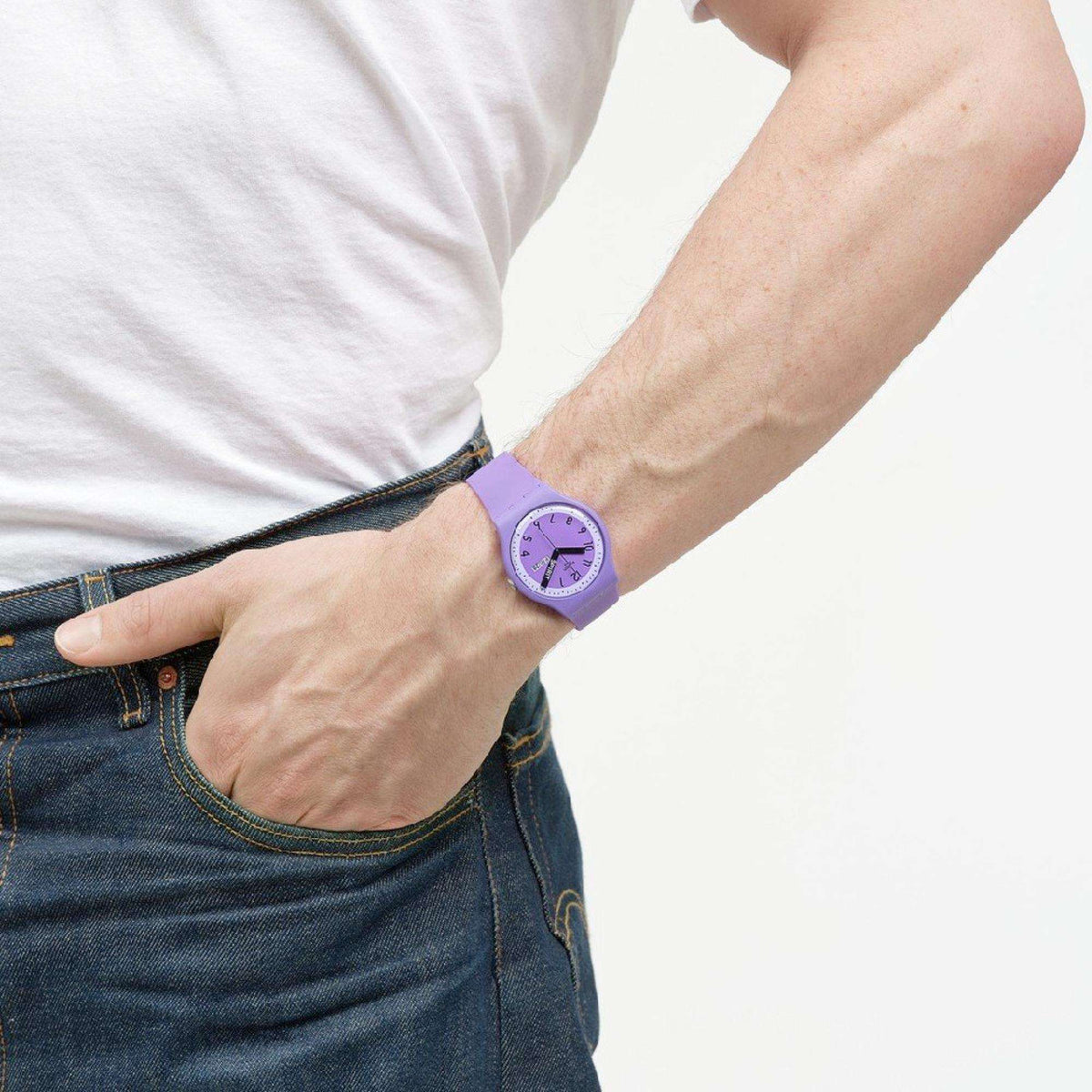 Purple quartz wristwatch on wrist with purple dial and silicone strap