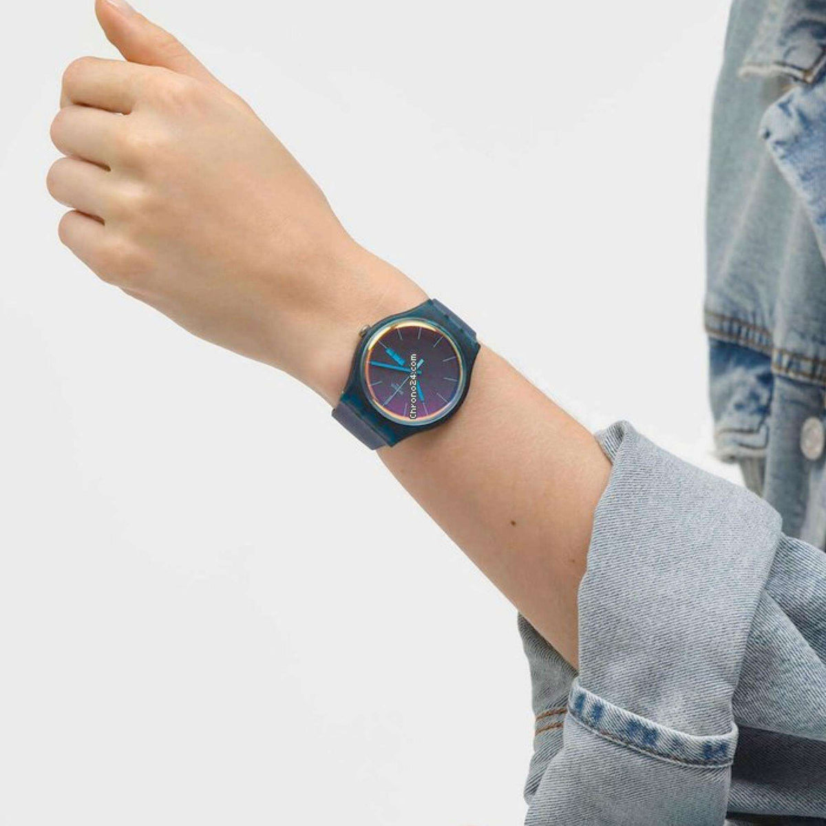 Teal dial quartz watch with blue silicone strap and orange hands, round case.