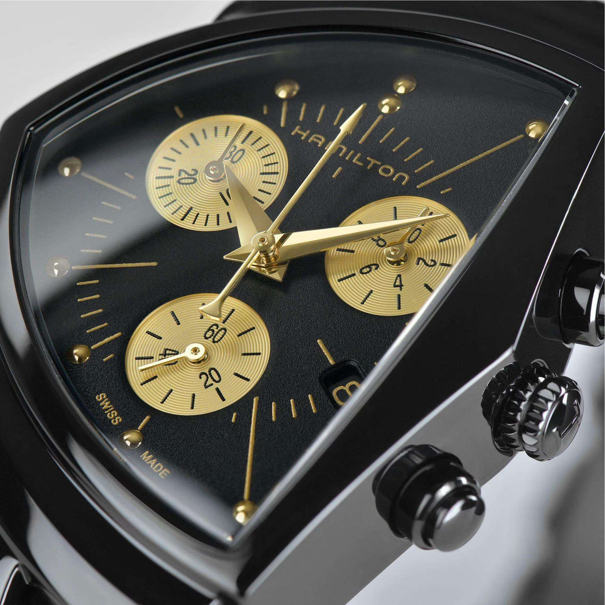 Hamilton Ventura chronograph watch close-up: black dial with gold hands and subdials