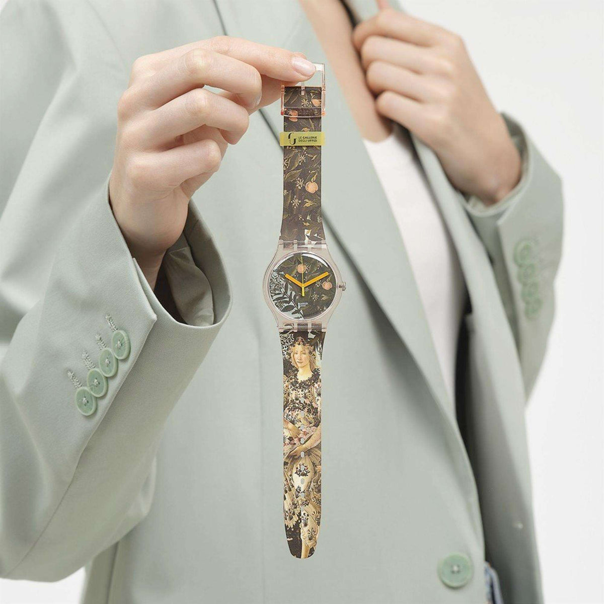 Quartz wristwatch on patterned brown-and-gold strap with pink case and orange hands
