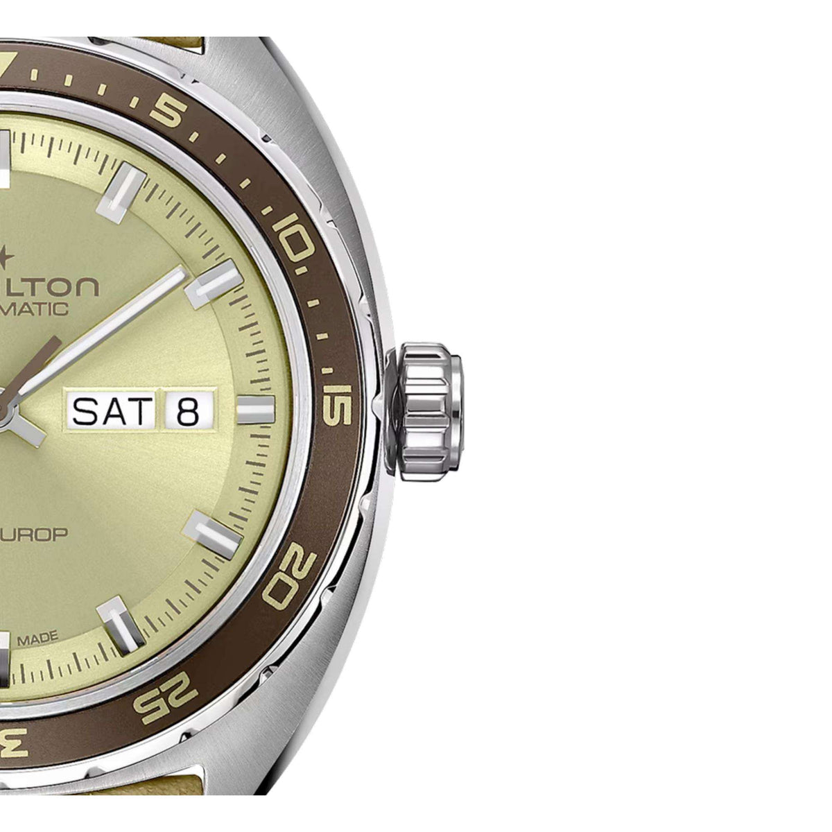 Men's watch close-up: day-date window on light green dial, silver case, dark bezel