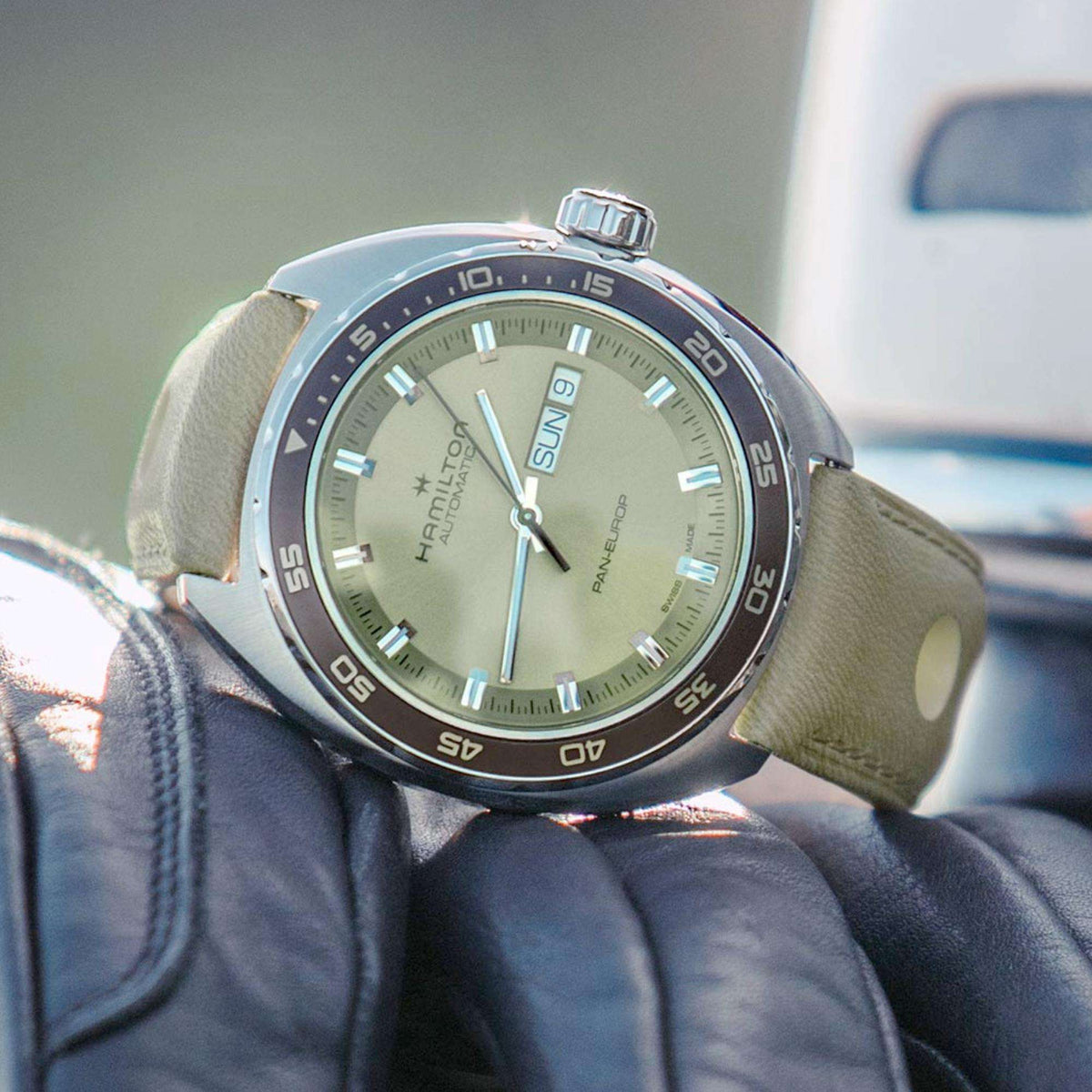 Automatic wristwatch with light green dial, silver case, green leather strap, day indicator