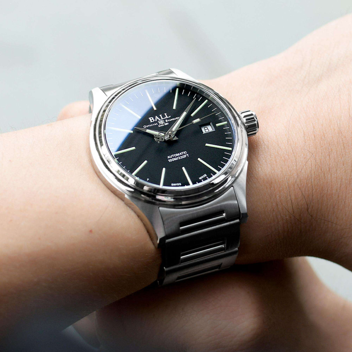 Men's automatic watch on wrist, dark navy dial with silver case and black steel band